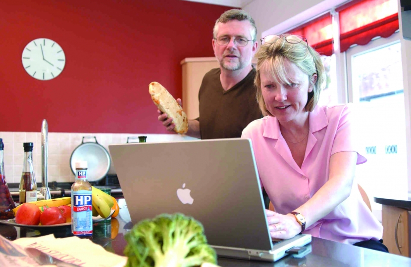Couple with Computer in Kitchen